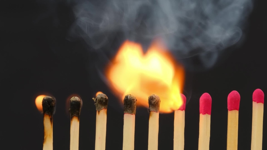 Burning matches against black. Stop epidemic. Domino effect. Social distancing concept footage. The spread of epidemics.  Royalty-Free Stock Footage #1061703028