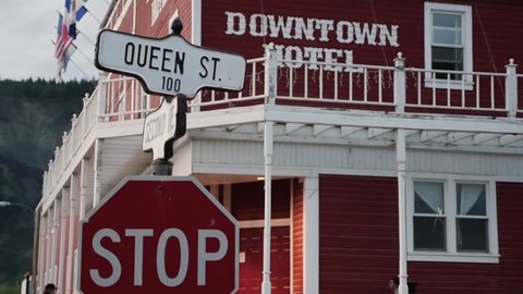 Dawson City , Yukon / Canada - 08 21 2014: Street panorama Queen St. with Downtown Hotel and road junction, panshot