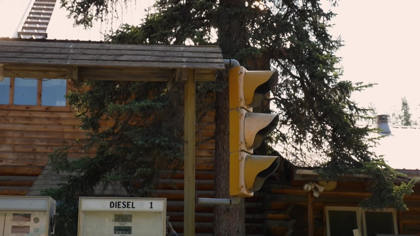 Vintage gas pumps in front of timber house in Alaska