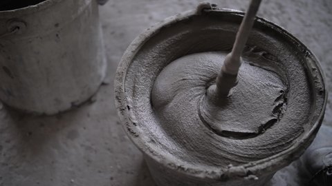 footage of mixing concrete mortar