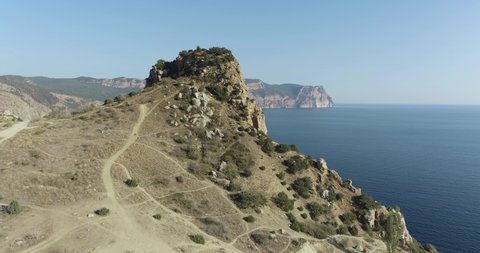 Beautiful sea rocky coast with cliffs in Crimea. Black sea, famous cape travel destination. Beautiful aerial drone view seascape at summer sunny day
