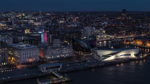 Establishing Aerial View of Liverpool UK, at night evening, City Waterfront, sideways center panorama, United Kingdom (part2)