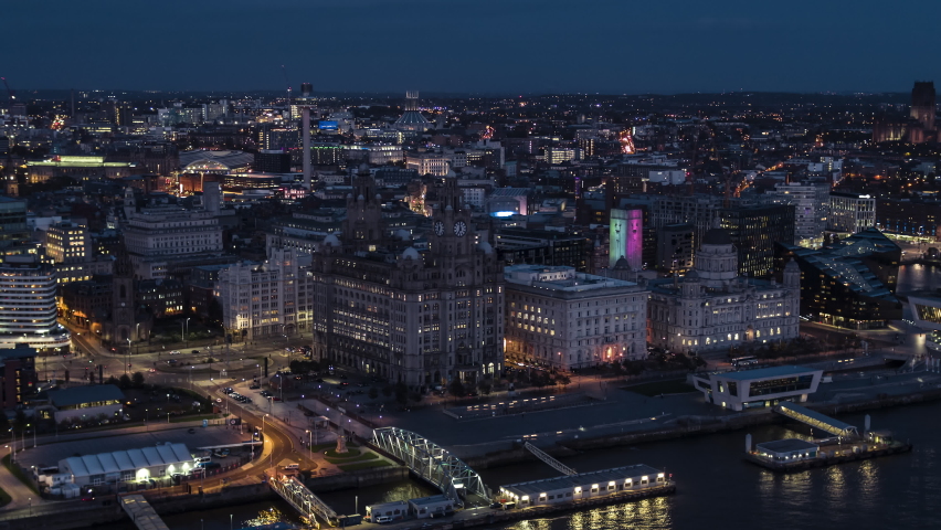 Establishing Aerial View of Liverpool UK, at night evening, City Waterfront, sideways center panorama, United Kingdom (part1) Royalty-Free Stock Footage #1061716789