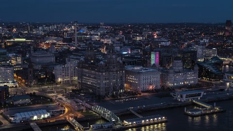 Establishing Aerial View of Liverpool UK, at night evening, City Waterfront, sideways center panorama, United Kingdom (part1)