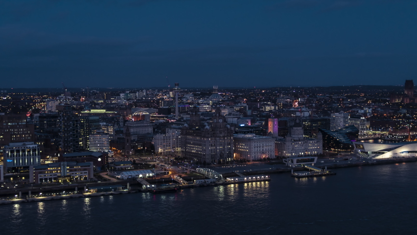 Establishing Aerial View of Liverpool UK, at night evening, slow track in, City Waterfront, United Kingdom Royalty-Free Stock Footage #1061716792