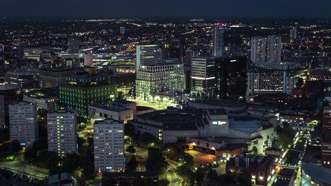 Aerial View Shot of Birmingham UK, magically lit, United Kingdom, night evening dusk