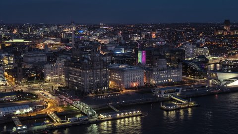 Establishing Aerial View Shot of Liverpool at night evening, City Waterfront & docks, United Kingdom