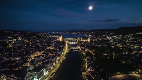 Aerial View Shot of Zurich, Wide Establishing at night evening, Iconic Old Town, Switzerland, moon up