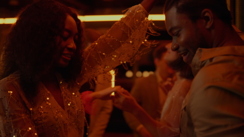 African american couple dancing on party in bar. Happy african man and woman having fun in nightclub. Joyful afro lovers moving with rhythm in luxury restaurant in slow motion. Royalty-Free Stock Footage #1061717755