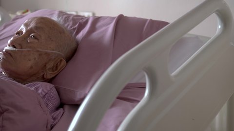 B-roll in 4K footage showing the Asian old man resting on the bed in hospital. Very old man has a critical health disease.