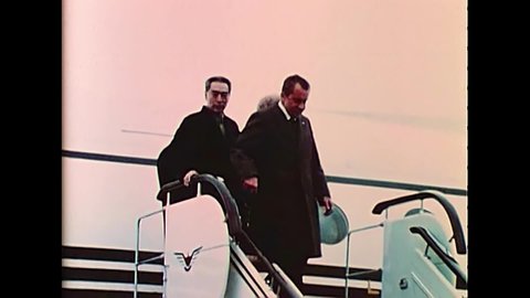 CIRCA 1972 - President Nixon, the First Lady and Premier Zhou disembark a plane in China.