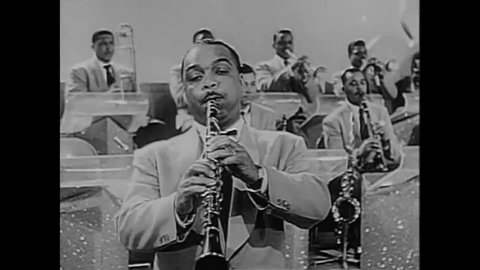 CIRCA 1955 - Duke Ellington's band plays "The Moochie," featuring clarinet and bass solos with Duke on the piano at the Harlem Variety Revue.