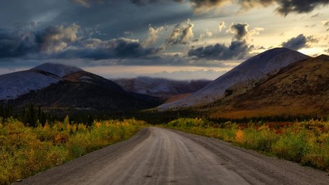 Cinemagraph Continuous Loop Animation. View of Scenic Road, Trees and Mountains on a Fall Day in Canadian Nature. Taken near Tombstone Territorial Park, Yukon, Canada.