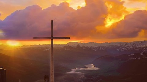 The cross of Jesus in nature at sunset for praise and worship. High quality 4k footage