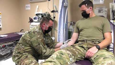 CIRCA 2020 - Masked 332 Air Expeditionary Wing Medical Group airmen blood transfusion training during COVID-19 pandemic.