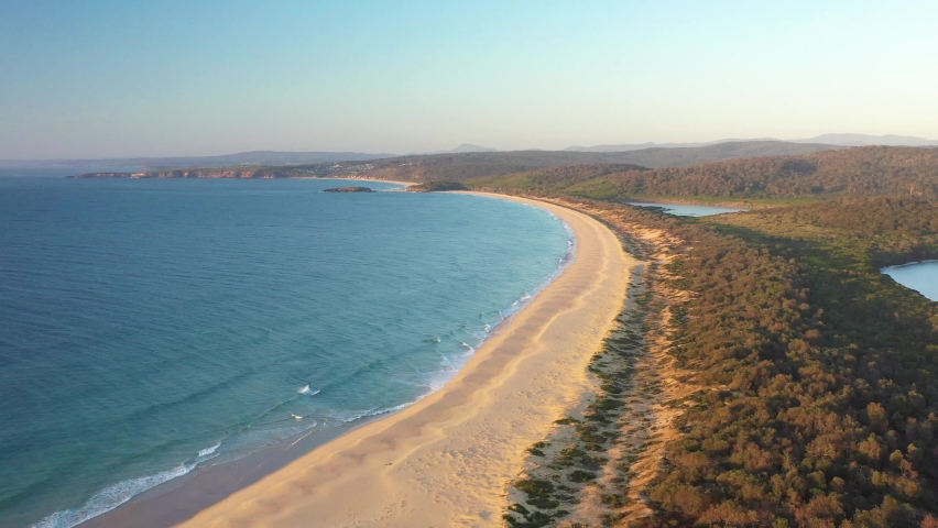 NEW SOUTH WALES, AUSTRALIA - CIRCA 2020 - An excellent aerial view of the coastline on Kianinny Bay at Bournda National Park. Royalty-Free Stock Footage #1061729830