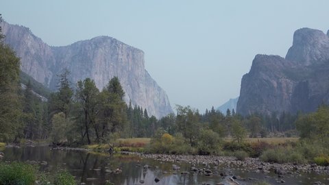 YOSEMITE NATIONAL PARK - CIRCA 2020 - Horizontal pan El Capitan, Merced River, Cathedral Rocks and the Yosemite Valley.