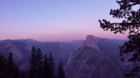 YOSEMITE NATIONAL PARK - CIRCA 2020 - Magenta alpen glow after sunset on Half Dome and High Sierra Nevada Mountains from Washburn Point, Yosemite NP. స్టాక్ వీడియో