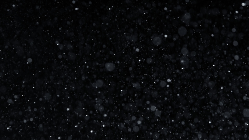 Super Slow Motion Shot of Falling Snow Flakes at 1000fps Isolated on Black Background.