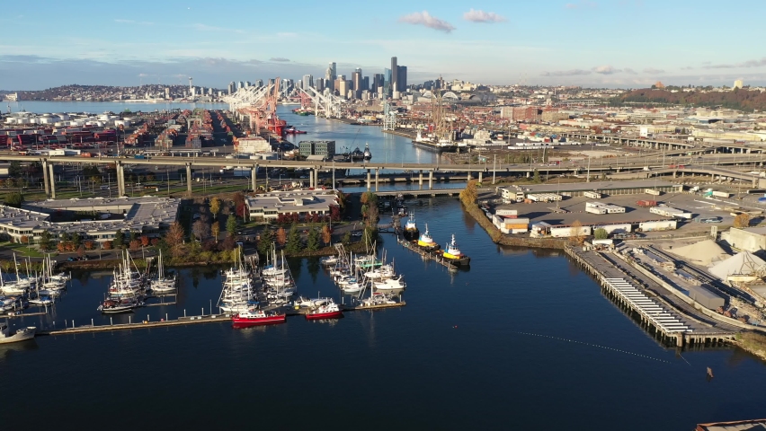Aerial / drone footage of West Seattle, the West Seattle bridge, docked ships at Harbor Island, Duwamish Waterway, Seattle Harbor terminals, Elliott Bay in Seattle, King County, Washington