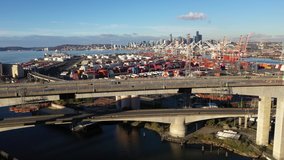 Aerial / drone footage of West Seattle, the West Seattle bridge, Harbor Island, oil tanks, Duwamish Waterway, Seattle Harbor terminals, Elliott Bay in Seattle, King County, Washington