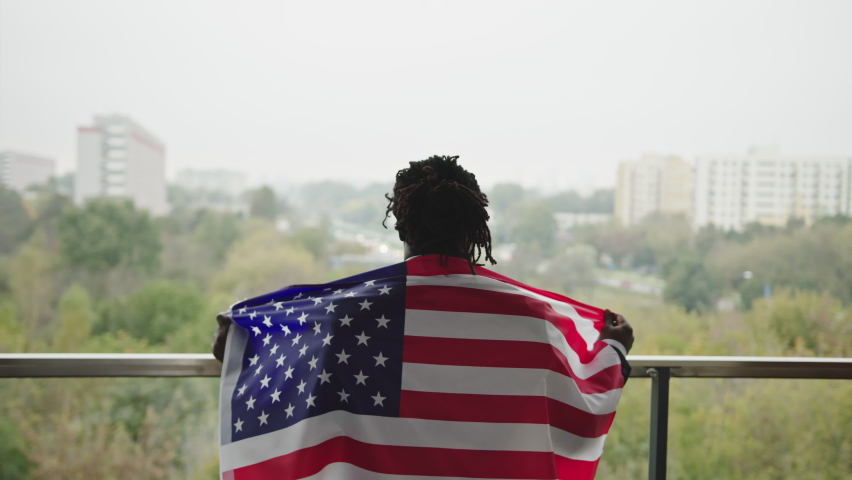 Proud black american celebrating citizenship with flag | Shutterstock HD Video #1061736136