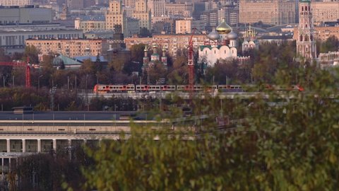 modern electric passenger train moving in the center of Moscow in late autumn