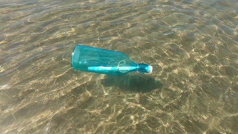Message in a bottle floating in the sea.