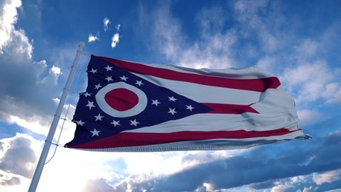Ohio flag on a flagpole waving in the wind, blue sky background. 4K