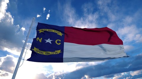 North Carolina flag on a flagpole waving in the wind, blue sky background. 4K