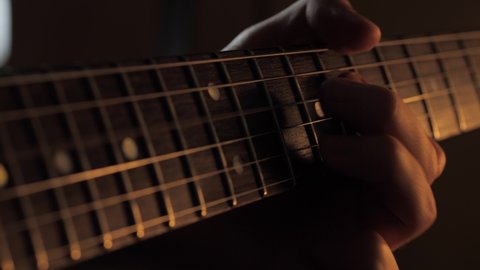 Playing electric guitar fretboard closeup
