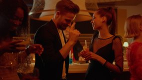 Multiethnic group of people dancing at night club party. Smiling friends celebrating birthday in luxury restaurant. Positive people having party in bar. Cheerful friends having rest in nightclub. - Powered by Shutterstock - Get 15% off with code: PIKWIZARD15