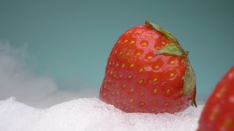 extreme close-up, detailed. red strawberries lie on dry ice in smoke.