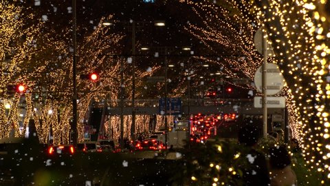 TOKYO, JAPAN - DECEMBER 2019 : Christmas illumination and snow at Omotesando and Harajuku shopping area. Scenery of downtown city and street at night. Japanese Winter and Christmas season concept.