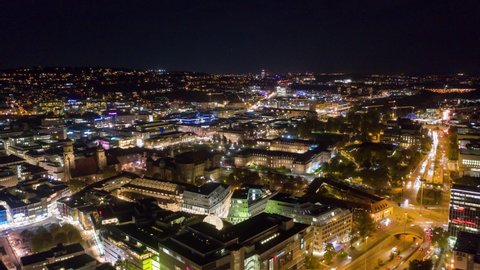 Moving aerial night time lapse in 4k of downtown skyline in the city of Stuttgart, Germany from left to right.