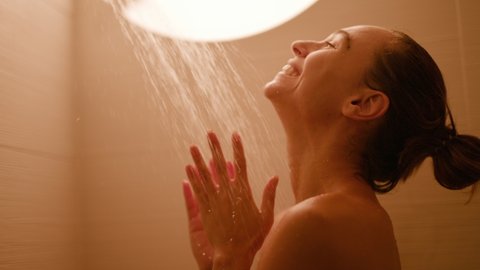 Woman taking a cold chill shower in the morning 