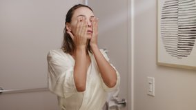 woman applying cream and scrub on her face in bathroom / skincare  - Powered by Shutterstock - Get 15% off with code: PIKWIZARD15