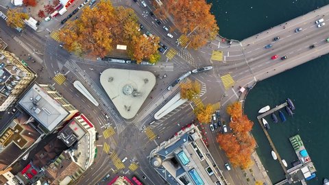 Top down view of a major intersection with tramway and cars where the Limmat river meet the lake in Zurich downtown, Switzerland largest city. Shot with a downward and rotation motion