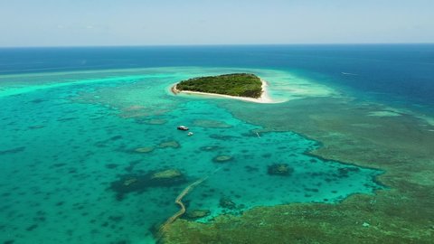Wild tropical island of the Great Barrier Reef in Australia called Lady Musgrave, white sand beach and clear azure water for snorkeling