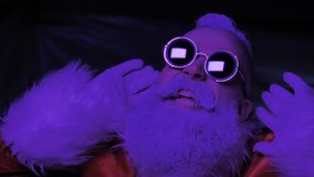 Energetic Crazy Excited Santa Claus Dances, Haves Fun in Vibrant Neon Lights at Modern Club Party Closeup Indoor. Happy Active Celebration of New Year, Christmas, Trendy Style of Holiday Entertainment - Powered by Shutterstock - Get 15% off with code: PIKWIZARD15