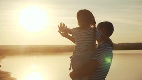 happy family dad and daughter by the sea at sunset silhouette. father and child kid reach out to the sun. kid a dream concept. happy family little girl and dad alone with relax nature sunset concept - Powered by Shutterstock - Get 15% off with code: PIKWIZARD15