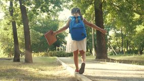 schoolgirl goes to school through the park along the path. kid dream concept. people in the park. schoolgirl goes school in the park education. schoolgirl walk after class with a backpack and book - Powered by Shutterstock - Get 15% off with code: PIKWIZARD15