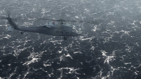 The helicopter flies over a stormy ocean. Production quality footage in ProRes 4444 codec, 25 FPS.