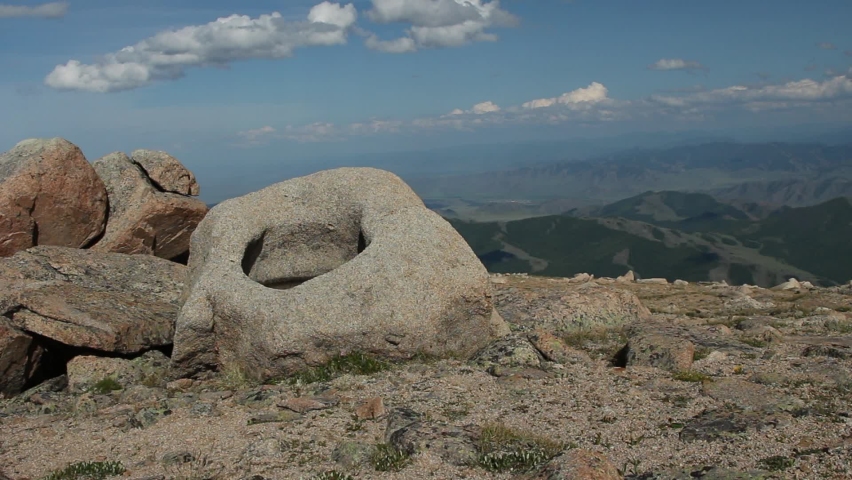 mountain landscape with stones mountains hills against the background of mountains and clouds with shadows from clouds floating in the mountains