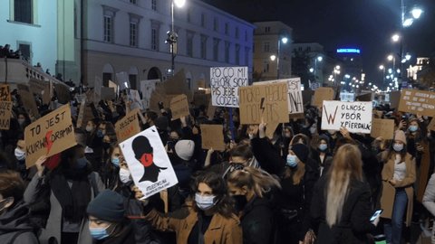 Poland Pro-Abortion Protests In City. Activists Wearing Masks Marching With Protest Signs. Warsaw, Poland, October 28, 2020.