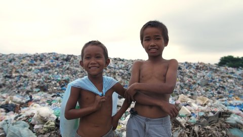 Happy Poor Children Standing With Garbage Dump
