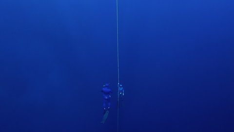 Two freedivers ascend along the rope. Freediving in the famous Blue Hole in the Red Sea in Egypt