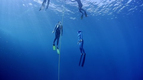 Freedivers ascend along the rope in the famous Blue Hole in the Red Sea in Egypt