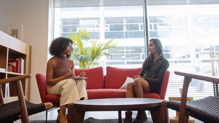 Two Businesswomen Having Informal Socially Distanced Meeting In Office During Health Pandemic | Shutterstock HD Video #1061794030