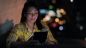 Young woman holding e-reader for hobby and leisure, lifestyle for people reading ebook while lying on sofa at night - Powered by Shutterstock - Get 15% off with code: PIKWIZARD15
